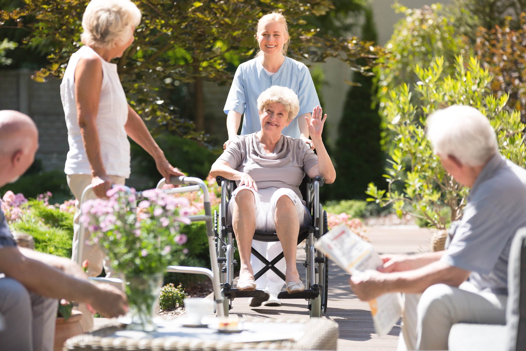 group of elderly with caregiver